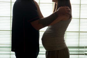 Silhouette of pregnant woman and man