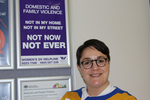 Lady next to the domestic and family violence poster