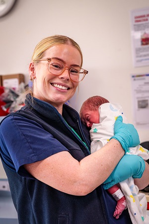 Midwife holding new born baby