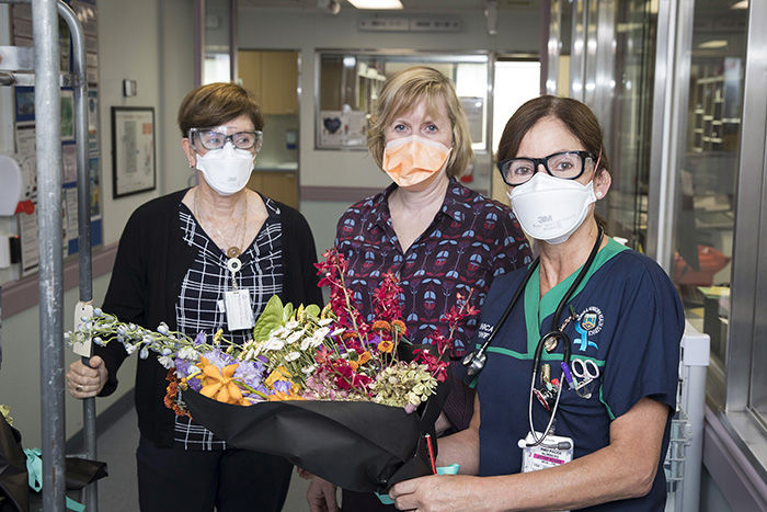 Executive Director Jodi Graham and hospital staff with bouquet of flowers 