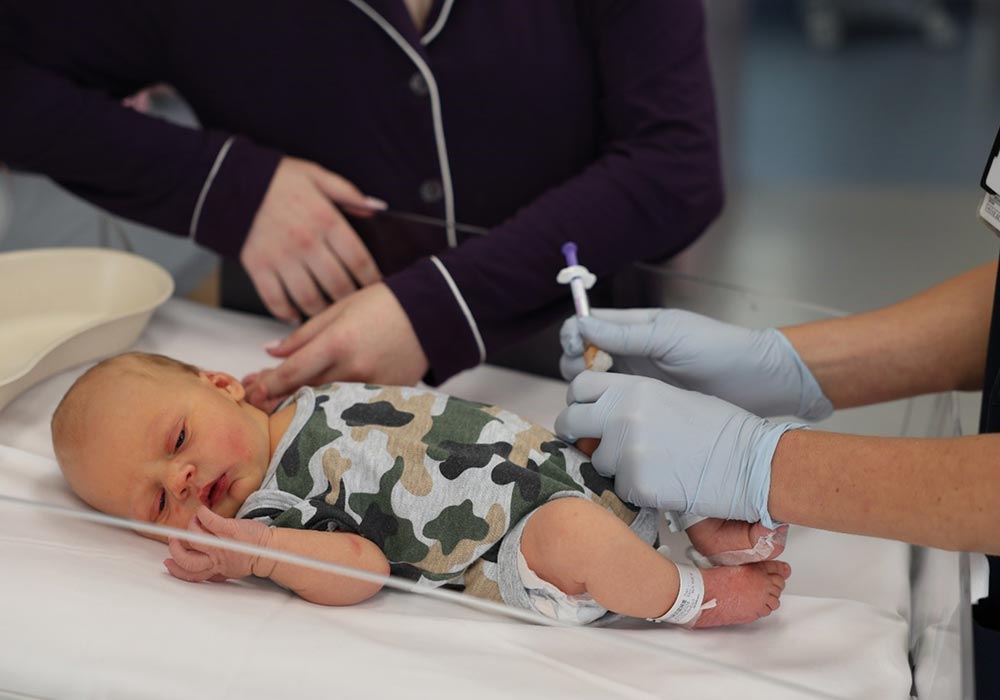 Infant being immunised